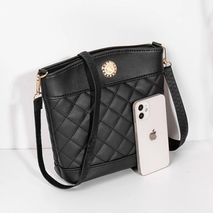 Quilted black leather bucket bag with diamond stitching and rhinestone gold buckle