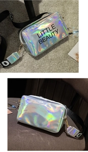 Detailed view of laser iridescent crossbody bag with 'LITTLE BEAUTY' print and wide strap