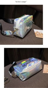 Detail of laser PVC bag featuring Little Beauty print and adjustable wide letter strap