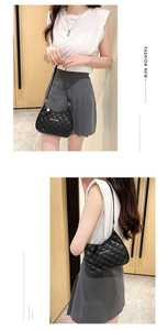 Detail showing the quilted rhombus pattern and Sunnyday gold metal logo on the black shoulder bag