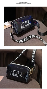 Detail of black glossy square bag with Little Beauty print and wide woven shoulder strap