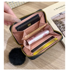 Detail of short leather wallet with multiple card slots and pink lining interior