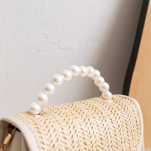 Mini straw woven handbag for women featuring a pearl beaded handle and chain strap