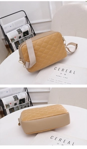Close-up of quilted fish-scale pattern and golden zipper on brown crossbody bag