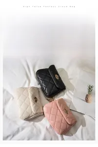 Detail of quilted shoulder bags in black, beige, and pink with metal twist locks