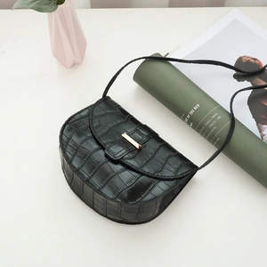Black crocodile embossed saddle shoulder bag with elegant gold metal lock clasp