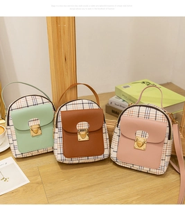 Detailed view of mini plaid backpacks in mint green, brown and pink with metal locks