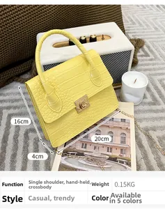 Detail view of yellow crocodile embossed mini bag showing 20x16x4cm size and 0.15kg weight