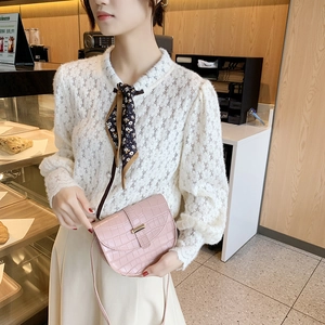 Pink crocodile pattern saddle bag styled with white lace shirt for an elegant look