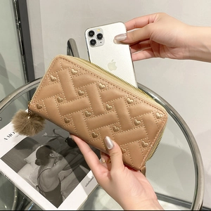 Brown leather zip-around long wallet with heart embroidery and pompom charm for women