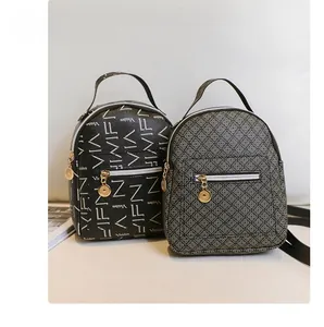 Detail of mini fashion backpacks with two distinct printed patterns and gold metal zippers