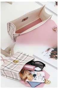 Interior view of pink plaid crossbody bag showing storage for phone, lipstick and perfume