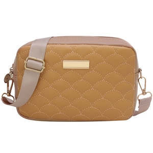 Mustard yellow quilted crossbody handbag with fish scale patterns and wide fabric strap