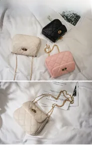 Detail of quilted crossbody bags in black, white, and pink with golden chain straps