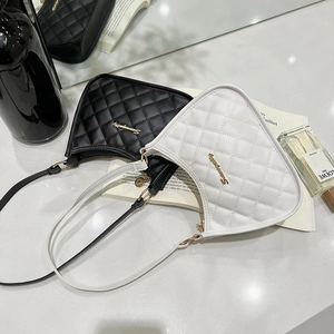Minimalist quilted crescent shoulder bag with metallic logo in black and white colors