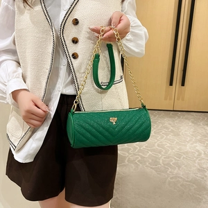 Green cylindrical barrel bag with V-shaped quilting and gold chain strap handle