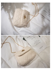 Detail of beige quilted chain bag with gold rotary lock and textured leather finish