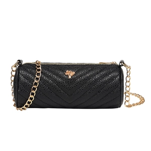 Minimalist black cylinder bag with V-quilted leather and golden tree logo and chain