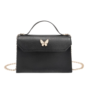 Minimalist black mini crossbody bag with golden butterfly clasp and chain strap