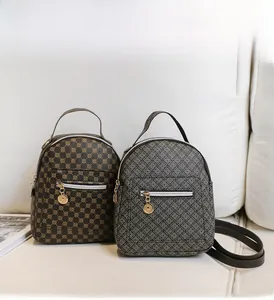 Mini floral backpacks with geometric patterns and circular charm detail on sofa