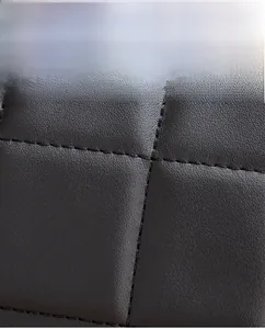 Close-up of quilted bovine two-layer leather showing fine grain and soft texture