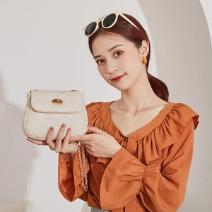 Chic beige quilted small crossbody bag with gold chain strap and metal clasp closure