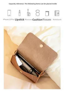 Detail showing the internal storage capacity of the brown embossed chain crossbody bag