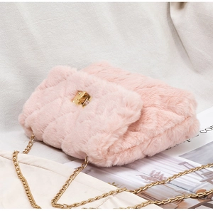 Detailed close-up of pink faux fur crossbody bag with gold chain and quilted pattern