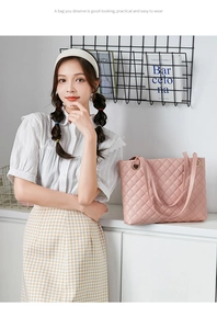 Lifestyle shot of pink quilted tote bag with gold ring hardware and dual shoulder straps