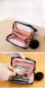 Detail of compact zipper purse with multiple card slots and pink lining interior