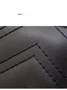 Macro shot of durable faux leather texture with precise double stitching on long wallet