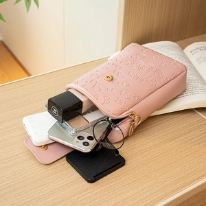 Pink embossed phone crossbody bag with compartments for smartphone and makeup