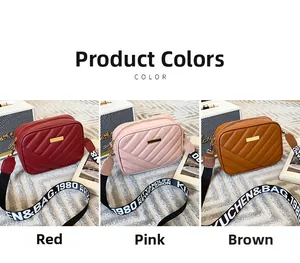 Three quilted crossbody bags in red, pink and brown with wide lettered shoulder straps