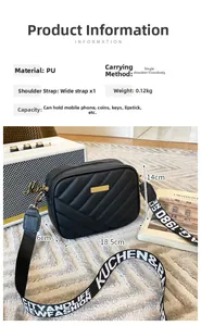 Detail of black quilted crossbody bag with gold hardware and printed wide strap