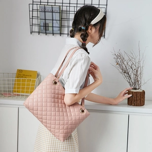 Pink quilted leather tote bag for women featuring large capacity and elegant shoulder straps