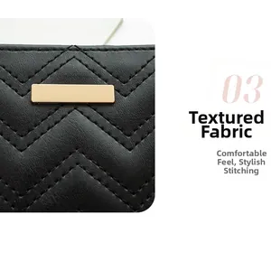 Detail of black quilted leather texture with V-shaped stitching and golden metal hardware