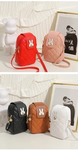 Close-up of quilted PU leather phone bags with cute rabbit metal buckles and straps