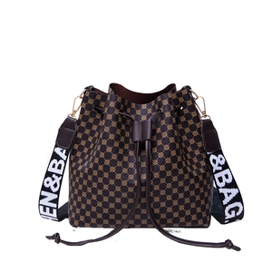 Brown vintage geometric bucket bag with drawstring and wide &BAG woven shoulder strap