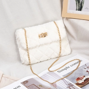 Elegant white faux fur shoulder bag with quilted texture and gold chain strap