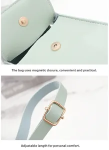Detail view of the magnetic buckle and adjustable shoulder strap buckle on a green handbag