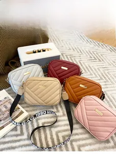 Five assorted colors of quilted small crossbody bags with stylish wide textile straps