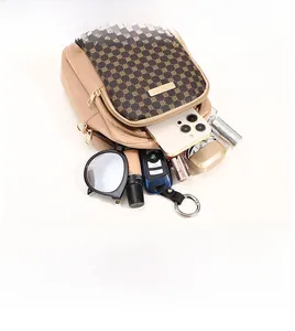 Crossbody phone bag detail showing large capacity for phone, sunglasses, and keys