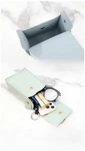 Interior layout of mint green mini crossbody bag showing storage for phone and lipstick