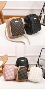 Close-up of four classic patterned small crossbody bags with dual zippers and gold hardware