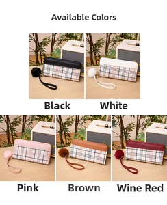 Detailed grid of long plaid wallets in five colors with wrist straps and pompom charms