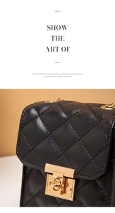 Detail of black quilted leather shoulder bag with gold clasp and elegant chain strap
