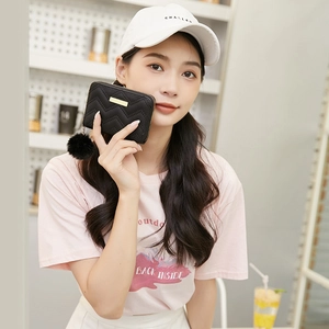 Short black quilted wallet for women with golden metal bar and plush pompom charm