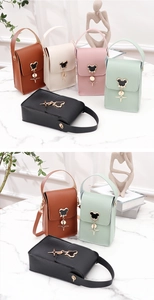 Detail view of mini crossbody bags with Mickey-shaped metal buckle and star charms