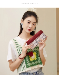 Detailed view of women long wallet with red leather stitching and classic plaid pattern