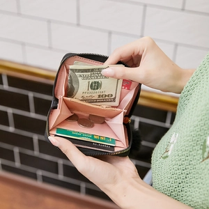Women's black faux leather mini wallet featuring gold zippers and multi-card slots